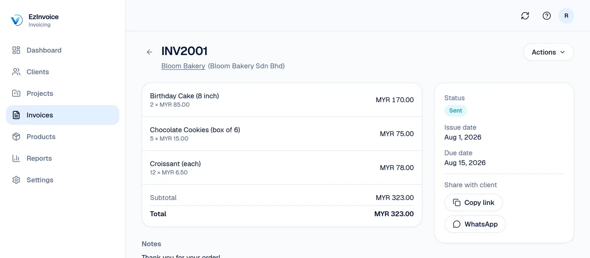 An invoice detail page showing line items, total, status, and share options